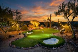 a golf course with a hole in the grass at Desert Oasis Pool, Golf, Games Mountain Views in New River