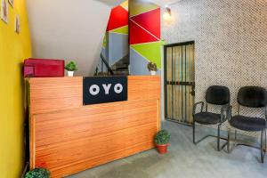 an office with a sign on a desk with chairs at Hotel O Green Park Residency 2 in New Delhi