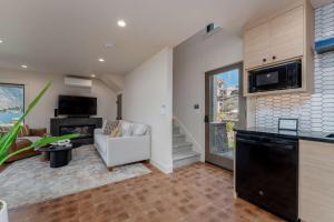 a kitchen and living room with a couch and a tv at High-end Lakefront Condo B6 Wapato Point Chelan in Manson +36 photos