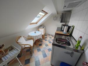a small kitchen with a sink and a table at Ferienwohnung Siegmund Dachboden in Waltershausen