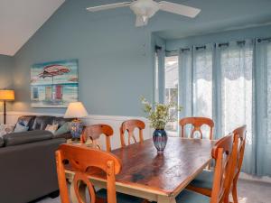 a dining room with a wooden table and chairs at 1228 Creekwatch Villa in Seabrook Island +32 photos