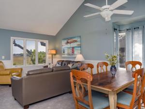 a living room with a table and a couch at 1228 Creekwatch Villa in Seabrook Island