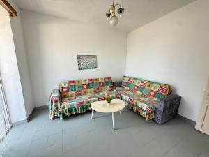 a living room with a couch and a table at Old Saranda Apartments in Sarandë