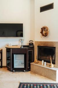 a living room with a fireplace and a flat screen tv at Serotonin Premium Collection in Balabanlı