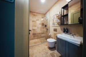 a bathroom with a toilet and a sink at Serotonin Premium Collection in Balabanlı +8 photos