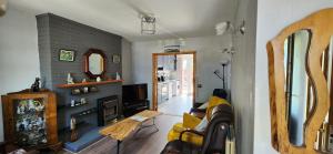 a living room with a couch and a fireplace at Cosy Bungalow in Balbriggan