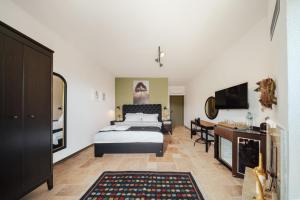 a bedroom with a bed and a desk and a television at Serotonin Premium Collection in Balabanlı