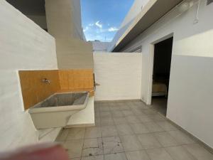 a bathroom with a sink on the side of a building at Apart Hotel RioSol in Concepción del Uruguay +57 photos