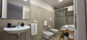 a bathroom with a sink and a toilet and a mirror at Bardia Guest House in Dorgali