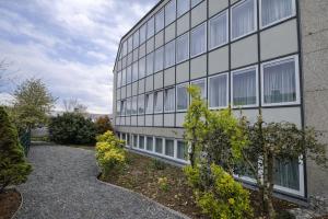 a building with a lot of windows on it at Check-Inn Hotel - free parking in Offenbach