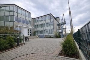 a large building with a spiral staircase in front of it at Check-Inn Hotel - free parking in Offenbach