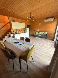 a dining room with a table and chairs and a couch at NorWay1 in Ijevan