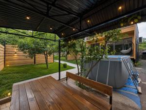 a patio with a wooden bench and a bath tub at NorWay1 in Ijevan