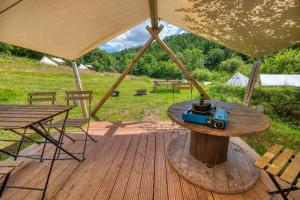 a table with a toy camera on top of it on a deck at Naturally Glamping in Kingsteignton