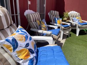 a group of chairs with pillows on them at Casa Muriana in Alanís