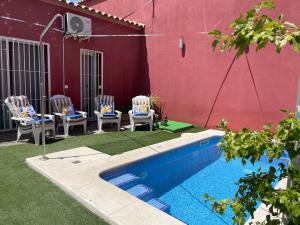 a patio with two chairs and a swimming pool at Casa Muriana in Alanís