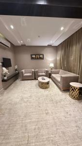 a large living room with couches and a table at قلب الشمال للشقق الفندقيه in Hail