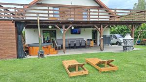 a patio with two picnic tables and a pool table at Dom letniskowy Sieraków in Sieraków +26 photos