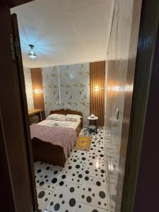 a bedroom with a bed and a tiled floor at Angevita City2 in Edéa