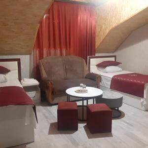 a room with two beds and a couch and a table at Noy in Goris +13 photos