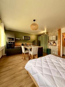 a bedroom with a bed and a table and chairs at Studio neuf parking proche centre-ville in Chambéry