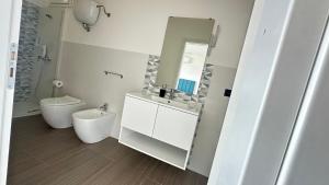 a bathroom with a sink and a toilet and a mirror at Torre Antica in Ioppolo +53 photos