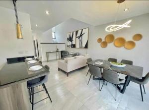 a living room with a table and chairs and a couch at By Lumina Parvasa 1 in Ejido Parras