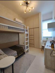 a bedroom with a bunk bed and a desk at By Lumina Parvasa 1 in Ejido Parras