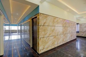a wooden wall in a room with a lobby at SPOT ON Sri Chowdeshwari Residency in Chik Bānavar