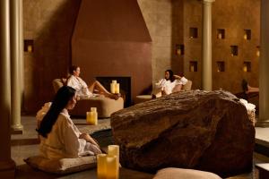 a group of people sitting in a room with a large rock at Mirbeau Inn & Spa Beacon in Beacon
