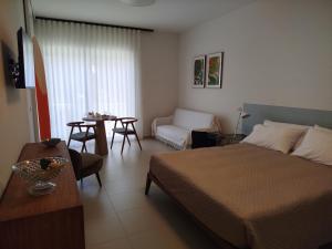 a bedroom with a bed and a couch and a table at Camere DOMOVIEW- design con vista su Cammarata in San Giovanni Gemini