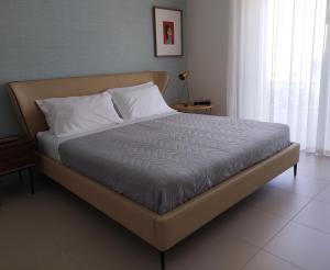 a large bed in a bedroom with at Camere DOMOVIEW- design con vista su Cammarata in San Giovanni Gemini