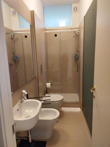 a bathroom with a sink and a toilet and a shower at Camere DOMOVIEW- design con vista su Cammarata in San Giovanni Gemini