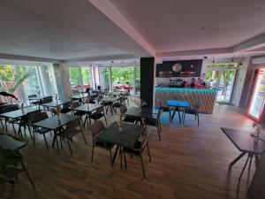 a restaurant with tables and chairs and a bar at Rosiem Boutique in Techirghiol