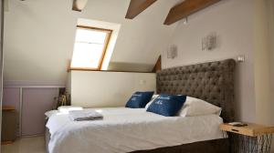 a bedroom with a large bed with blue pillows at Nadmorska Miła in Gdańsk