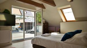 a bedroom with a bed and a sliding glass door at Nadmorska Miła in Gdańsk +78 photos