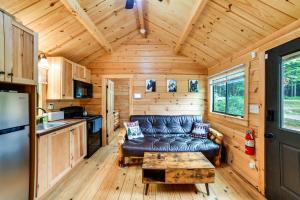 a living room with a couch in a tiny house at Catskills Tiny Home Cabin: Surrounded by Nature! in Franklin