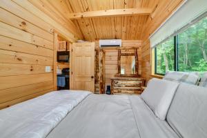 a bedroom with a bed in a tiny house at Catskills Tiny Home Cabin: Surrounded by Nature! in Franklin