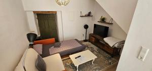 a small living room with a couch and a television at Studio "Werkstatt" in Oberndorf in Oberndorf am Neckar