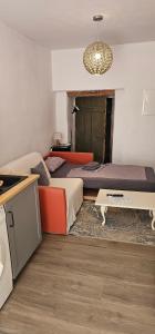 a bedroom with a bed and a table and a chandelier at Studio "Werkstatt" in Oberndorf in Oberndorf am Neckar