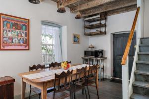 a dining room with a wooden table and chairs at Historic Rumpel Kammer - Compound in Fredericksburg
