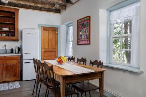 a kitchen with a wooden table and chairs at Historic Rumpel Kammer - Compound in Fredericksburg