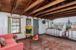 a bedroom with a bed and a couch and a table at Historic Rumpel Kammer - Compound in Fredericksburg
