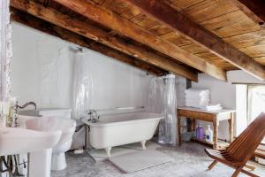 a white bathroom with a tub and a sink at Historic Rumpel Kammer - Compound in Fredericksburg +35 photos