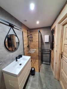 a bathroom with a white sink and a shower at Mazurska Widokówka in Węgorzewo +26 photos