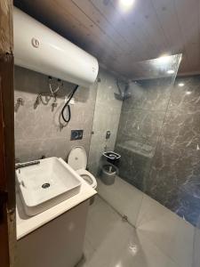 a small bathroom with a sink and a toilet at River Retreat Resort in Pahalgām