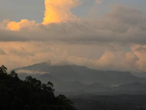 a cloudy sky with a mountain in the distance at Hotel Velmont Kandy in Kandy +32 photos