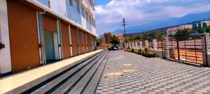 an empty street next to a building at Skvr Grand in Theni