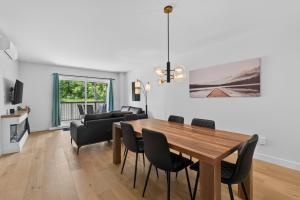 a dining room with a wooden table and chairs at 200-214 - Le Niveau 2 in Beaupré