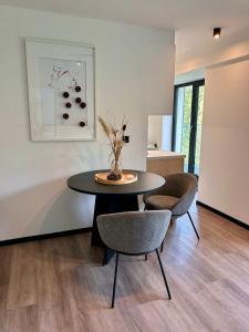 a dining room with a table and two chairs at Apartmán podlesí in Havířov +33 photos
